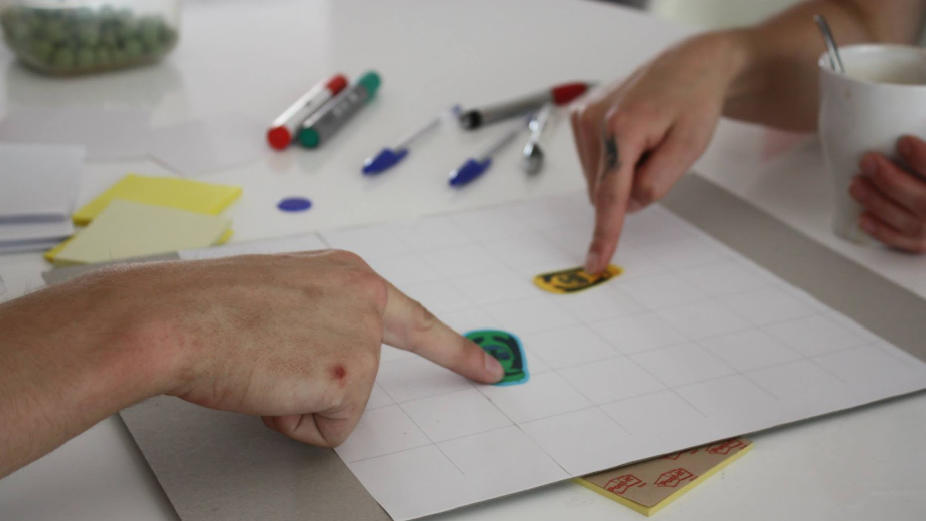 Gamestorm: two people testing movement patterns of pieces